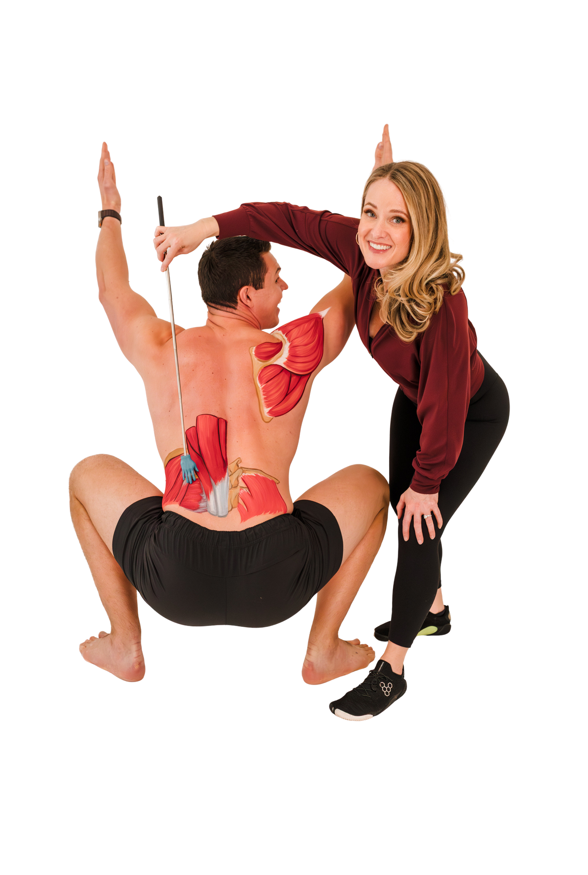 Andrew demonstrating an overhead squat with back anatomy, alongside Katie.